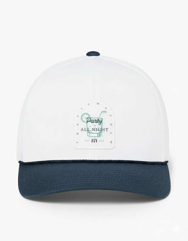 TravisMathew Beer Break Hat in white with navy brim and rope detail, featuring a ‘Party All Night’ cocktail graphic patch on the front panel.