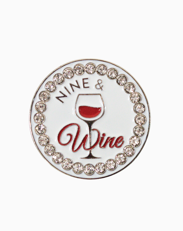 Circular golf ball marker featuring the words “Nine & Wine” with a red wine glass graphic in the center, surrounded by sparkling clear Swarovski crystals on a white background.